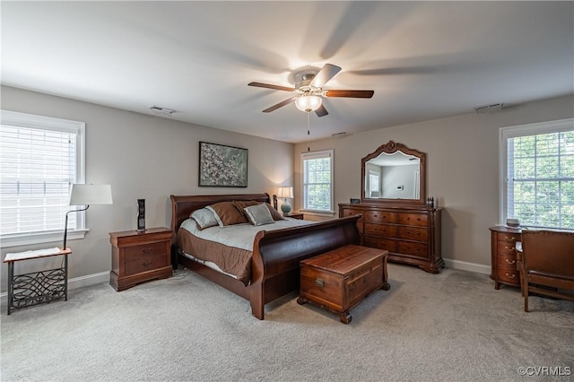 bedroom with light carpet, visible vents, and baseboards