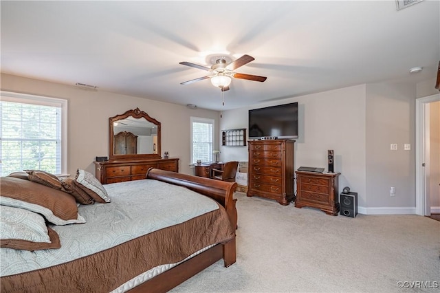 carpeted bedroom featuring visible vents, a ceiling fan, and baseboards