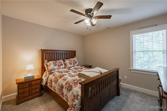 bedroom with baseboards, visible vents, ceiling fan, and carpet flooring