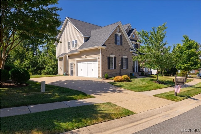 view of front of house with an attached garage, a front lawn, concrete driveway, and brick siding