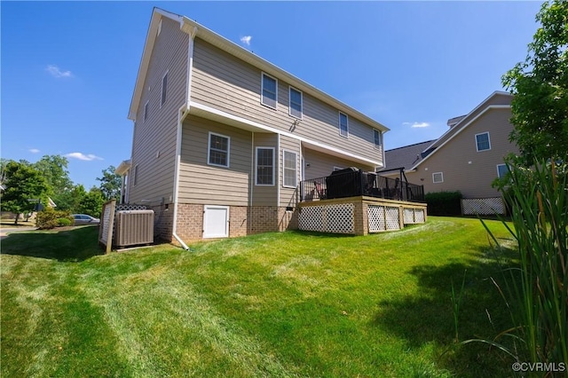 back of house featuring a yard, a wooden deck, and central air condition unit