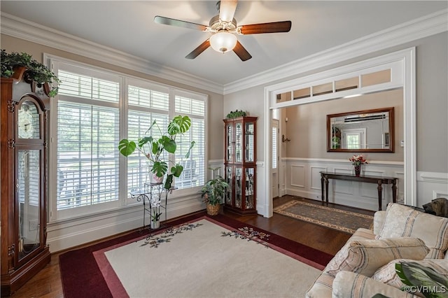 interior space with crown molding, a wainscoted wall, wood finished floors, and a healthy amount of sunlight