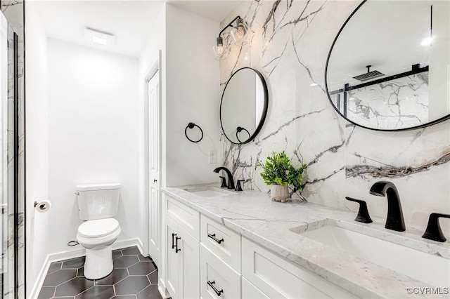 full bathroom with a sink, toilet, double vanity, and tile patterned floors