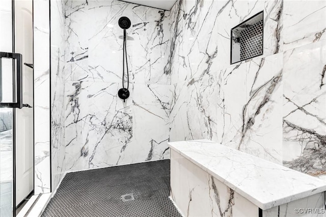 bathroom with a marble finish shower