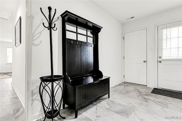 mudroom with baseboards, visible vents, plenty of natural light, and marble finish floor