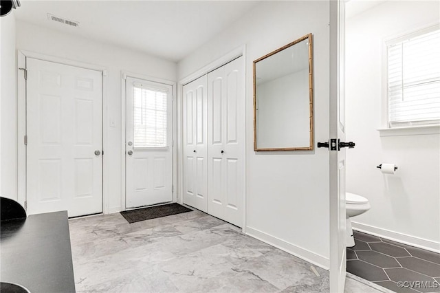 entryway with visible vents, marble finish floor, and baseboards