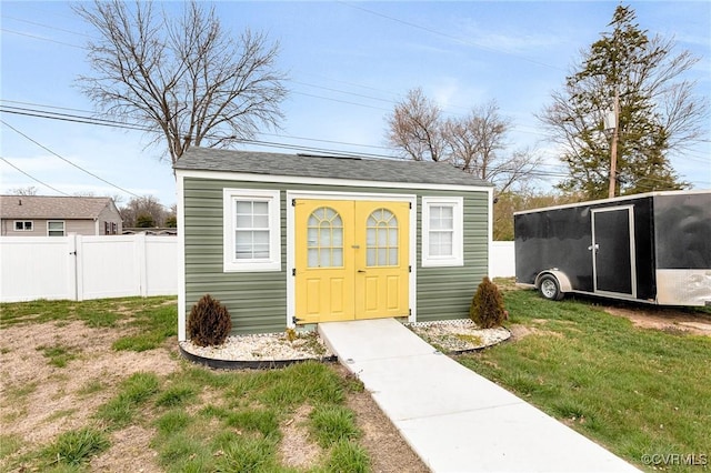 view of outbuilding featuring an outbuilding and fence