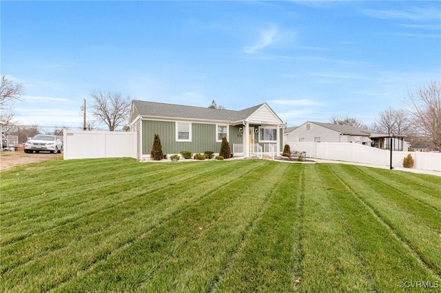 view of front of house with a porch, a front yard, and fence