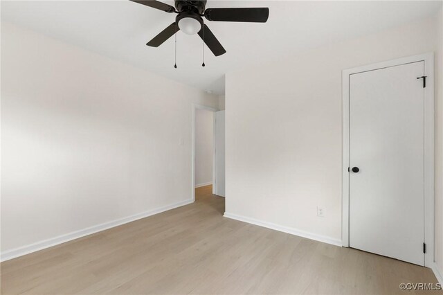 unfurnished room with a ceiling fan, baseboards, and light wood finished floors