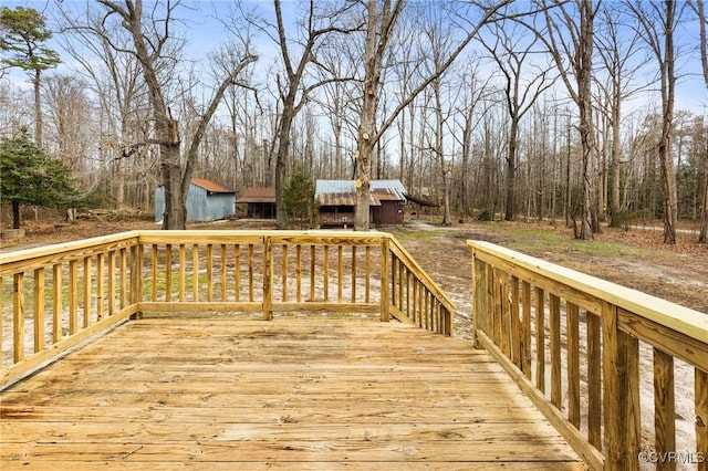 wooden terrace featuring an outbuilding