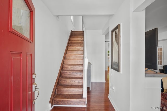 stairs with baseboards and wood finished floors