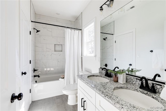 full bath with double vanity, shower / tub combo, a sink, and toilet