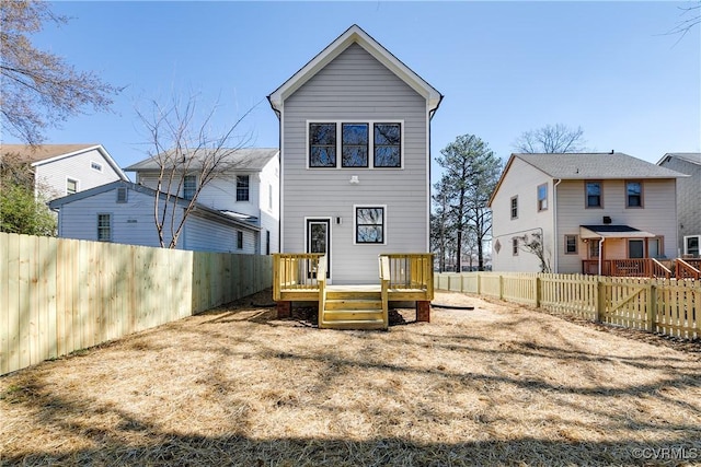 back of property featuring a fenced backyard and a deck