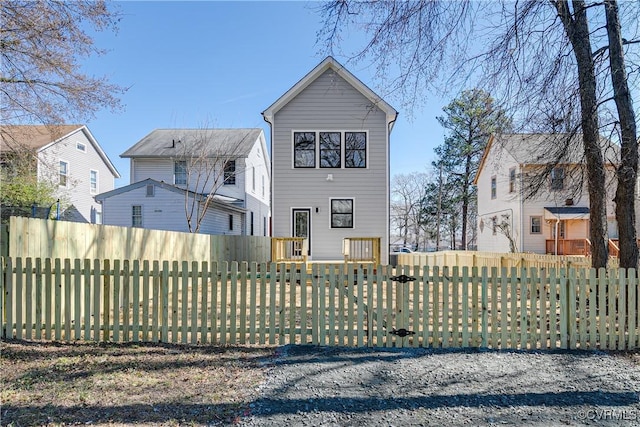 view of front of house with a fenced front yard and a gate