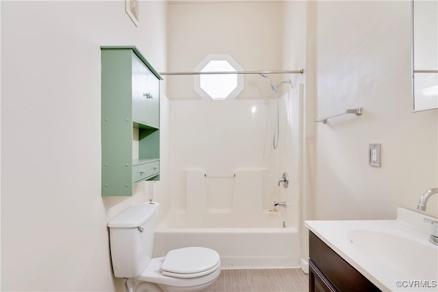 bathroom featuring washtub / shower combination, vanity, and toilet