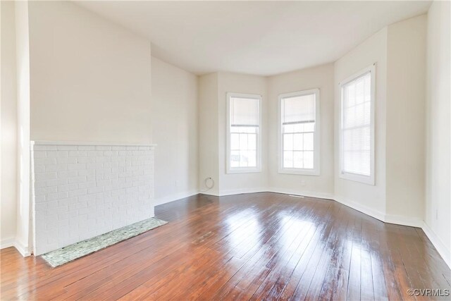 empty room featuring dark wood-style flooring and baseboards