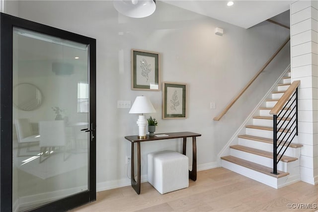 interior space with baseboards, stairway, wood finished floors, and recessed lighting