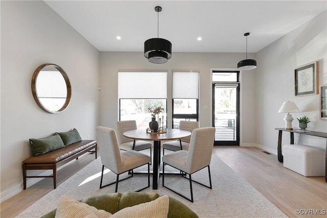 dining space with light wood-type flooring, baseboards, and recessed lighting