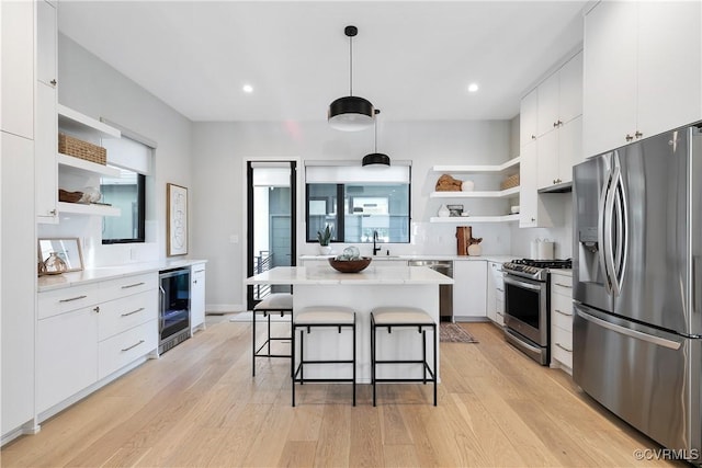 kitchen with beverage cooler, stainless steel appliances, a sink, a kitchen breakfast bar, and open shelves