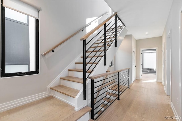 stairs featuring baseboards and wood finished floors