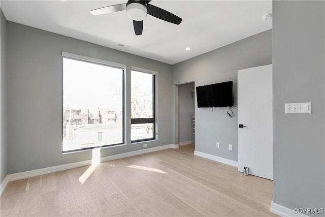 interior space with light wood-type flooring, ceiling fan, baseboards, and recessed lighting