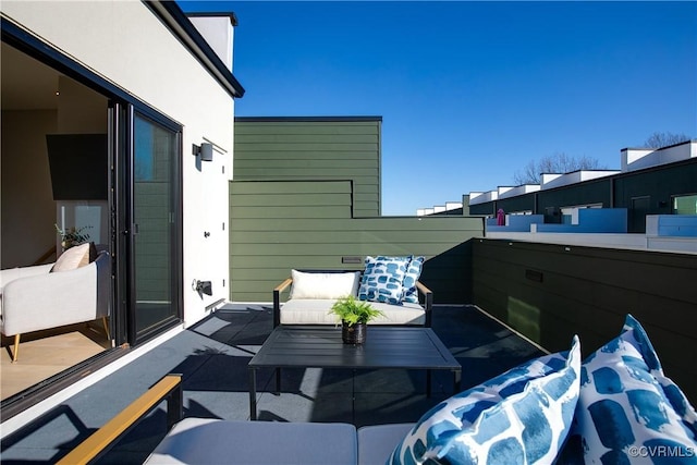 view of patio featuring a balcony and an outdoor hangout area