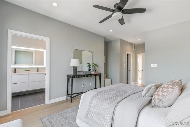 bedroom with recessed lighting, wood finished floors, a ceiling fan, baseboards, and ensuite bath