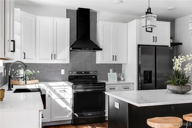 kitchen featuring black / electric stove, a sink, refrigerator with ice dispenser, wall chimney exhaust hood, and tasteful backsplash