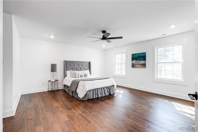 bedroom with multiple windows, dark wood-style flooring, recessed lighting, and baseboards