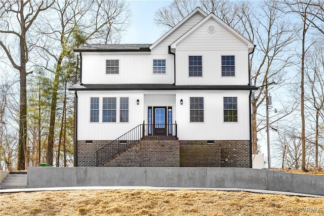 view of front of property with a shingled roof and crawl space