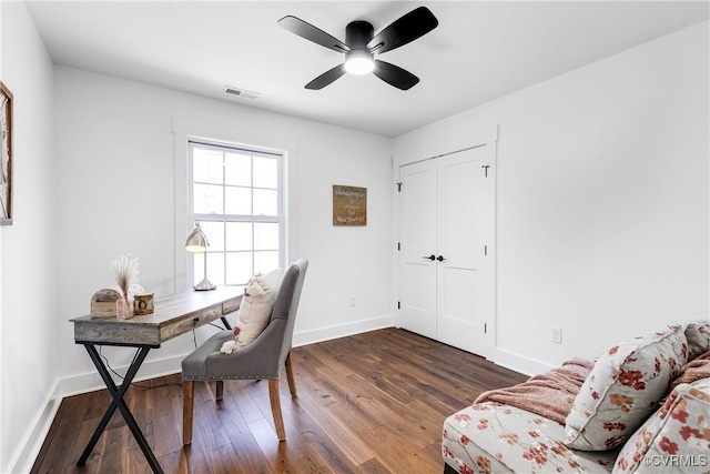 office area with a ceiling fan, visible vents, baseboards, and wood finished floors