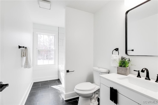 bathroom featuring tile patterned flooring, baseboards, vanity, and toilet