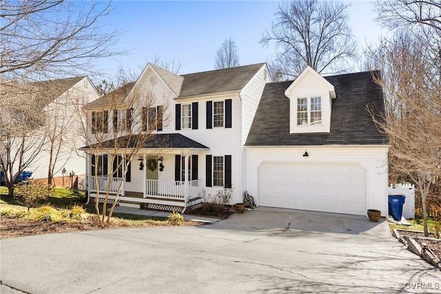 colonial inspired home featuring driveway, a porch, and an attached garage