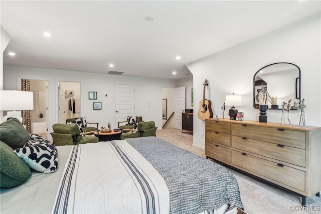 bedroom featuring a spacious closet, visible vents, light colored carpet, and recessed lighting