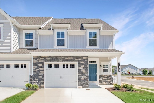 multi unit property featuring driveway, a shingled roof, a garage, and board and batten siding