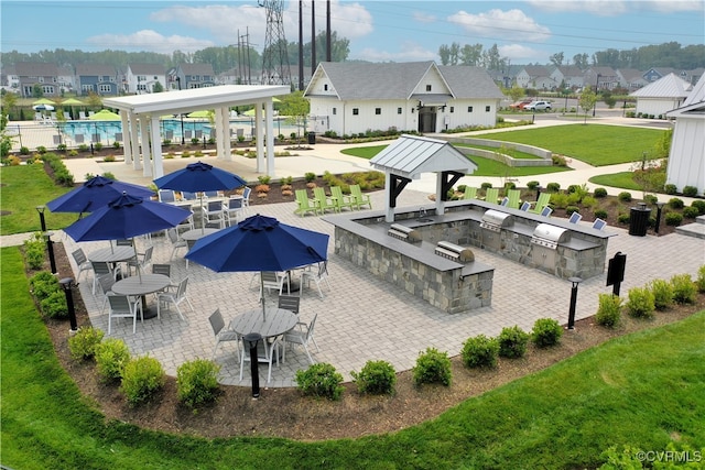 exterior space featuring a lawn, a residential view, fence, a gazebo, and a patio area