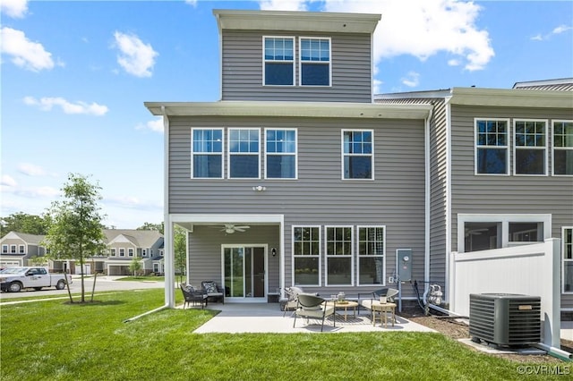 back of house featuring a patio area, ceiling fan, a lawn, and central AC