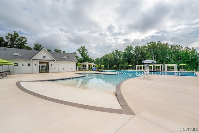 community pool featuring a patio area, fence, and a pergola