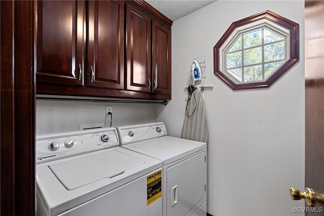 laundry room featuring cabinet space, separate washer and dryer, and a textured ceiling