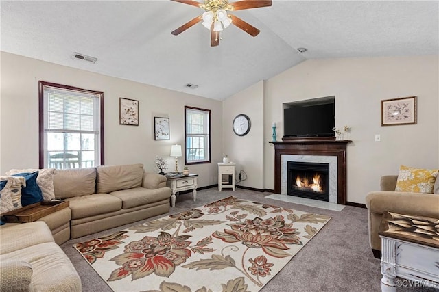 living room featuring baseboards, visible vents, vaulted ceiling, and carpet flooring