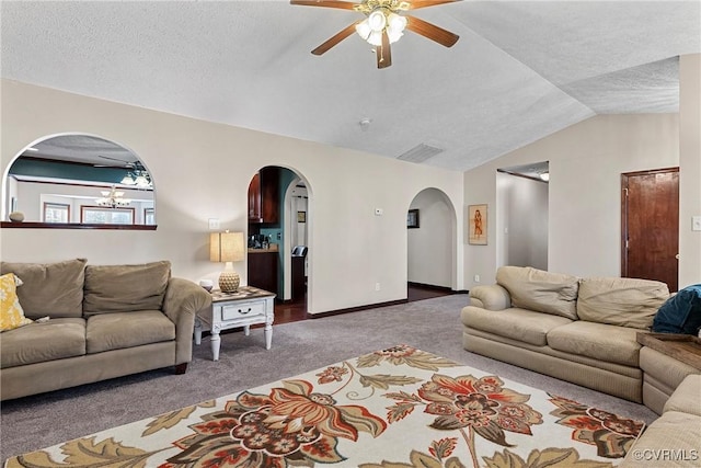 living room featuring baseboards, visible vents, vaulted ceiling, a textured ceiling, and carpet floors