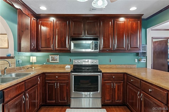 kitchen with visible vents, stainless steel appliances, a sink, and light countertops