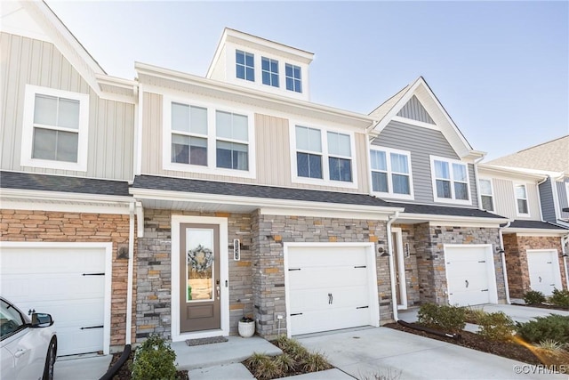 multi unit property with a garage, driveway, a shingled roof, and board and batten siding