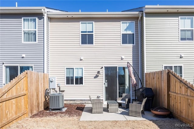 back of house with cooling unit, a patio area, and a fenced backyard