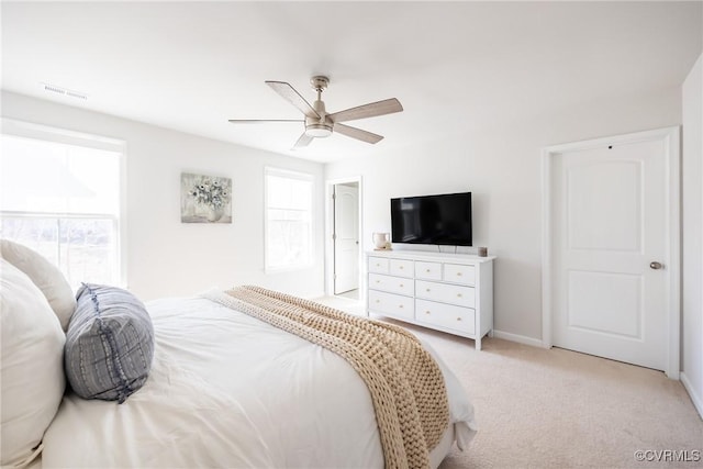 bedroom with visible vents, ceiling fan, light carpet, and baseboards