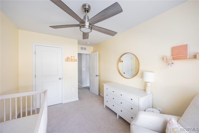 bedroom featuring light carpet, ceiling fan, visible vents, and baseboards