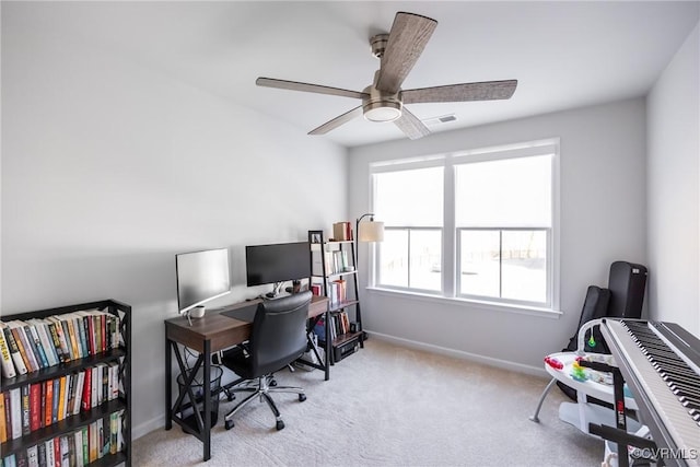 carpeted home office with a ceiling fan, visible vents, and baseboards