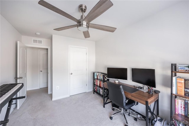 office with a ceiling fan, carpet, visible vents, and baseboards