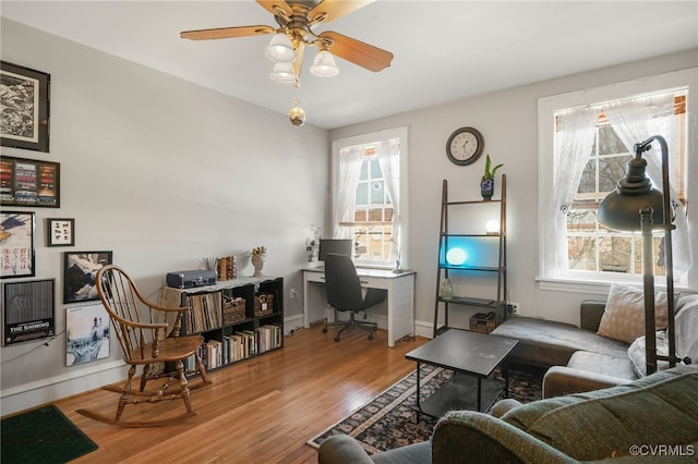 office area with ceiling fan, wood finished floors, and baseboards