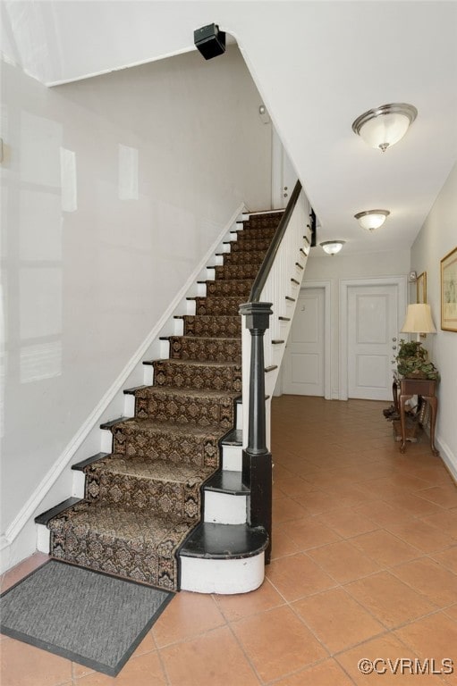 stairs featuring tile patterned flooring